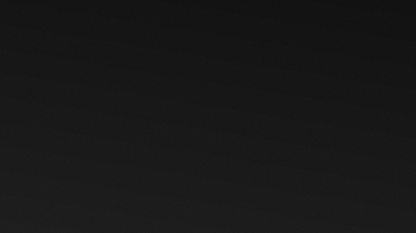 A dimly lit interior film set, lit with a single practical source